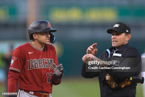 Nick Ahmed of the Arizona Diamondbacks talks to home plate umpire Brock Ballou after a time violation in the top of the fourth inning against the...