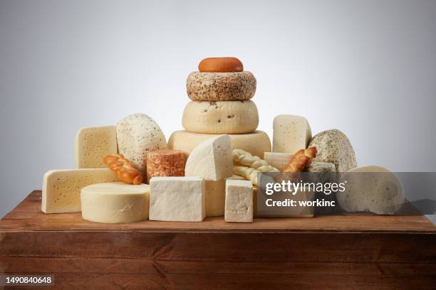 different types of cheeses over table - rustic font stock pictures, royalty-free photos & images