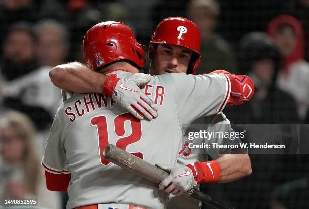 Kyle Schwarber of the Philadelphia Phillies is congratulated with a hug from J.T. Realmuto after after Schwarber hit a solo home run against the San...