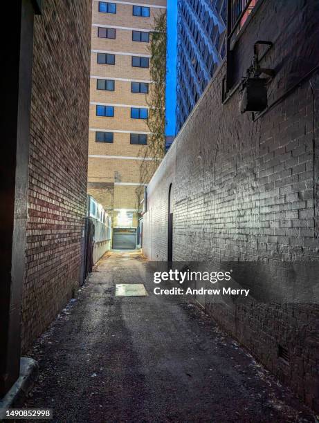 city night dark alley light glowing - company town hall stock pictures, royalty-free photos & images