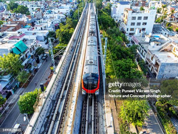 a metro train for local travel in lucknow, uttar pradesh - indian trains stock pictures, royalty-free photos & images
