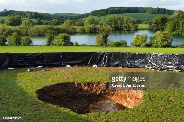 This aerial view shows a large sink hole after it appeared above a section of HS2 tunnelling in a field by Shardeloes Lake, May 16, 2023 in Amersham,...