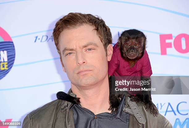 Actor Justin Kirk and Crystal the Monkey arrive at the 2012 Teen Choice Awards at Gibson Amphitheatre on July 22, 2012 in Universal City, California.