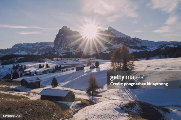 magnificent picture of gorgeous dolomites mountain landscape with traditional wooden cabins at alpe di siusi at beautiful autumn sunset, south tyrol, northern italy. - alta badia - fotografias e filmes do acervo