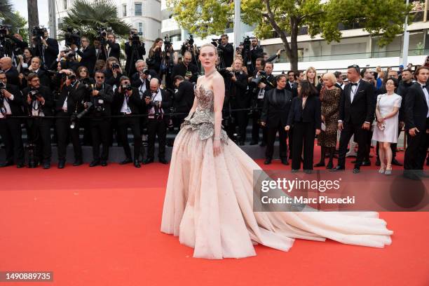 Elle Fanning attends the "Jeanne du Barry" Screening & opening ceremony red carpet at the 76th annual Cannes film festival at Palais des Festivals on...