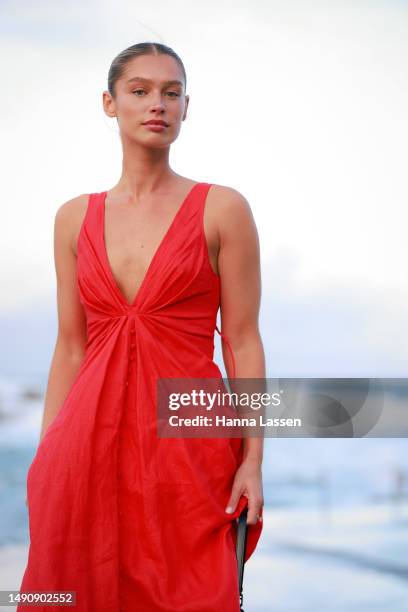 Guest wearing Joslin red maxi dress at Afterpay Australian Fashion Week 2023 at Carriageworks on May 17, 2023 in Sydney, Australia.