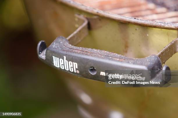 Witten, Germany, : The Weber logo on a handle on the Weber grill on May 14, 2023 in Witten, Germany.