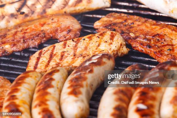 Witten, Germany, : Turkey steak and sausages and meat on a grill on May 14, 2023 in Witten, Germany.