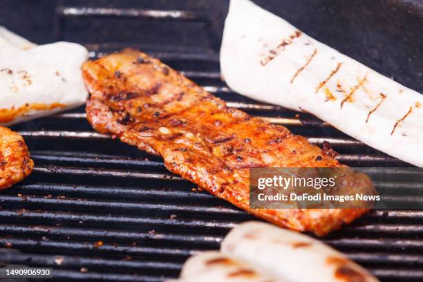 Witten, Germany, : A slice of bacon on a grill on May 14, 2023 in Witten, Germany.