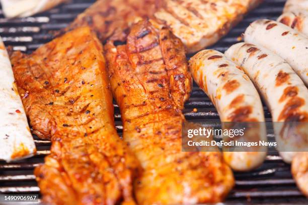 Witten, Germany, : Slice of bacon on a grill on May 14, 2023 in Witten, Germany.