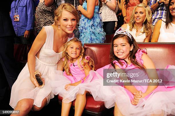 Musician Taylor Swift with Rosie McClelland and Sophia Grace Brownlee in the audience during the 2012 Teen Choice Awards at Gibson Amphitheatre on...