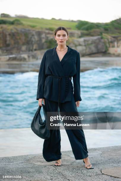 Holly Lyle wearing black suit and black Bottega Veneta bag at Afterpay Australian Fashion Week 2023 at Carriageworks on May 17, 2023 in Sydney,...