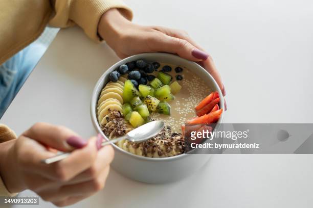 woman holding smoothie in a bowl - tahini stock pictures, royalty-free photos & images