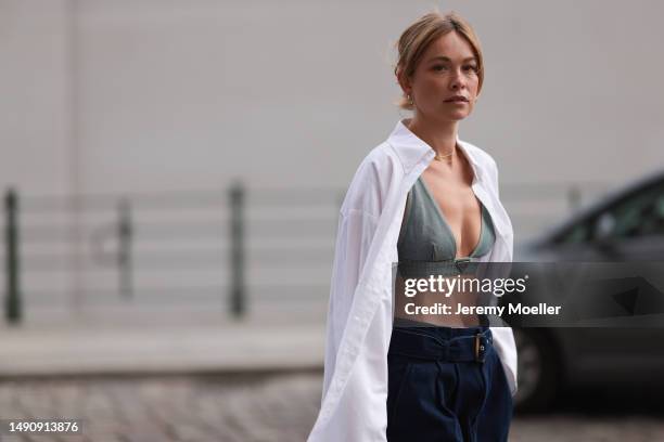 Nadine Berneis seen wearing Prada denim black logo bra, Diesel 1DR mini denim babyblue handbag, Closed wide leg dark blue denim belt pants, black...