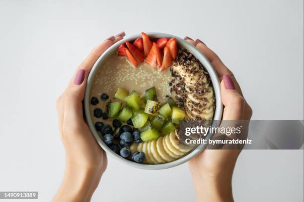 woman holding smoothie in a bowl - tahini stock pictures, royalty-free photos & images