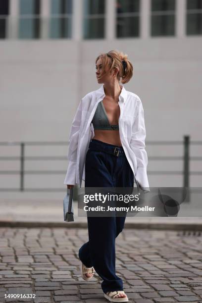 Nadine Berneis seen wearing Prada denim black logo bra, Diesel 1DR mini denim babyblue handbag, Closed wide leg dark blue denim belt pants, black...