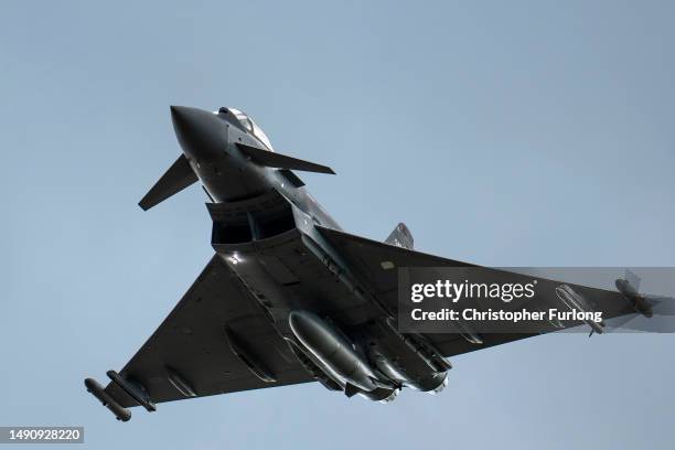 British Royal Air Force Eurofighter Typhoon fighter aircraft flies at RAF Coningsby on May 16, 2023 in Coningsby, England. RAF Coningsby is home to...