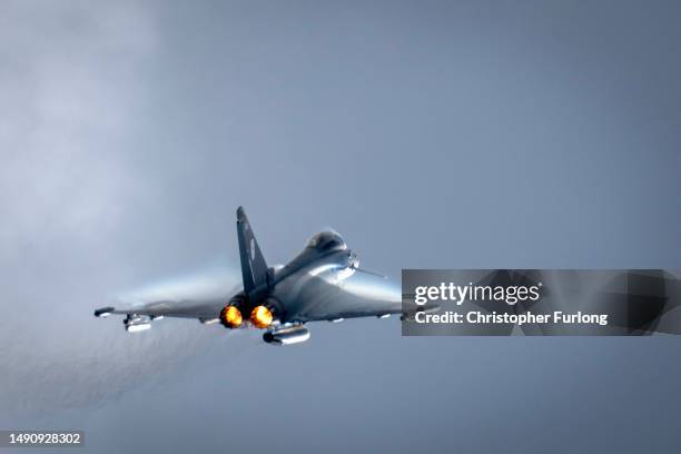 British Royal Air Force Eurofighter Typhoon fighter aircraft flies at RAF Coningsby on May 16, 2023 in Coningsby, England. RAF Coningsby is home to...