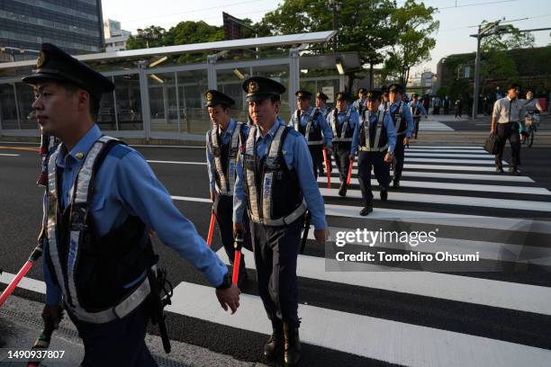 Police officers cross a road near the Hiroshima Peace Memorial Park ahead of the Group of 7 summit on May 17, 2023 in Hiroshima, Japan. The G7 summit...