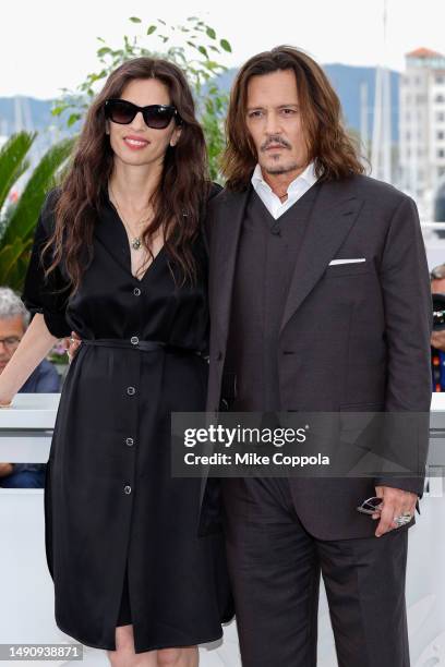 Maïwenn and Johnny Depp attend the "Jeanne du Barry" photocall at the 76th annual Cannes film festival at Palais des Festivals on May 17, 2023 in...