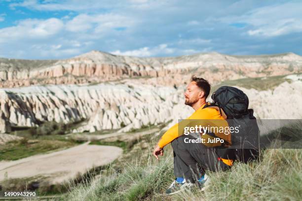 young adult man travelling around cappadokia mountains, goreme - göreme national park stock pictures, royalty-free photos & images