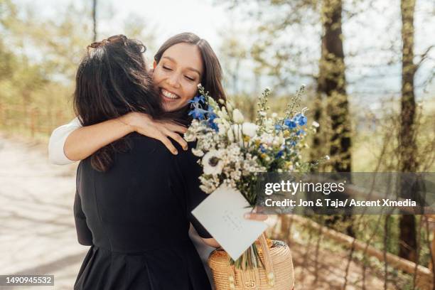 bride embraces friend outdoors - wedding gift stock pictures, royalty-free photos & images