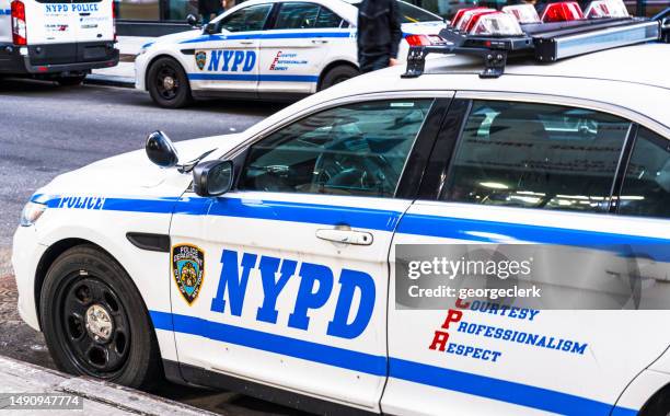 nypd vehicles on the street in manhattan - nypd transit stock pictures, royalty-free photos & images