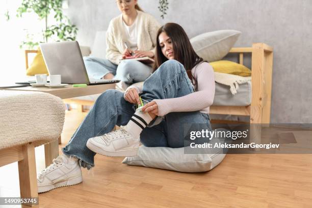 female cheating on exams by putting notes in socks - wrong socks stock pictures, royalty-free photos & images