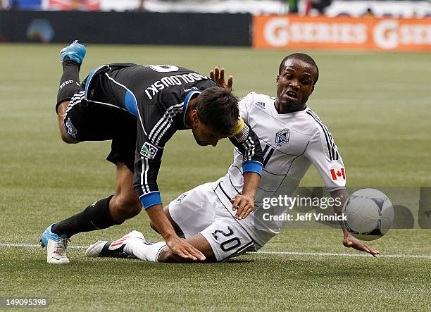 Chris Wondolowski of the San Jose Earthquakes and Dane Richards of the Vancouver Whitecaps FC battle for the ball during their MLS game July 22, 2012...