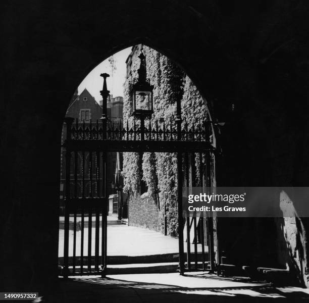 The gated entrance to Dean's Yard in Westminster, London, England, June 1949. The gateway is viewed from the arch leading to the cloisters of...