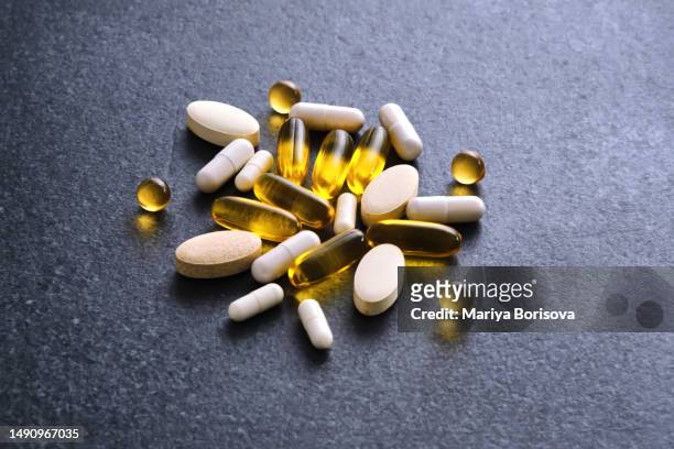 tablets, vitamins and dietary supplements on a dark table. - vitamins and minerals imagens e fotografias de stock