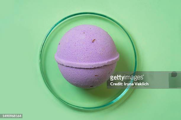 trendy  beauty product bath bomb with  lavender plant ekstrakt. - bath bomb stock pictures, royalty-free photos & images