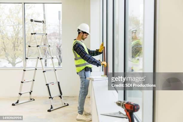 mid adult male construction worker inside the empty building - refurbished stock pictures, royalty-free photos & images