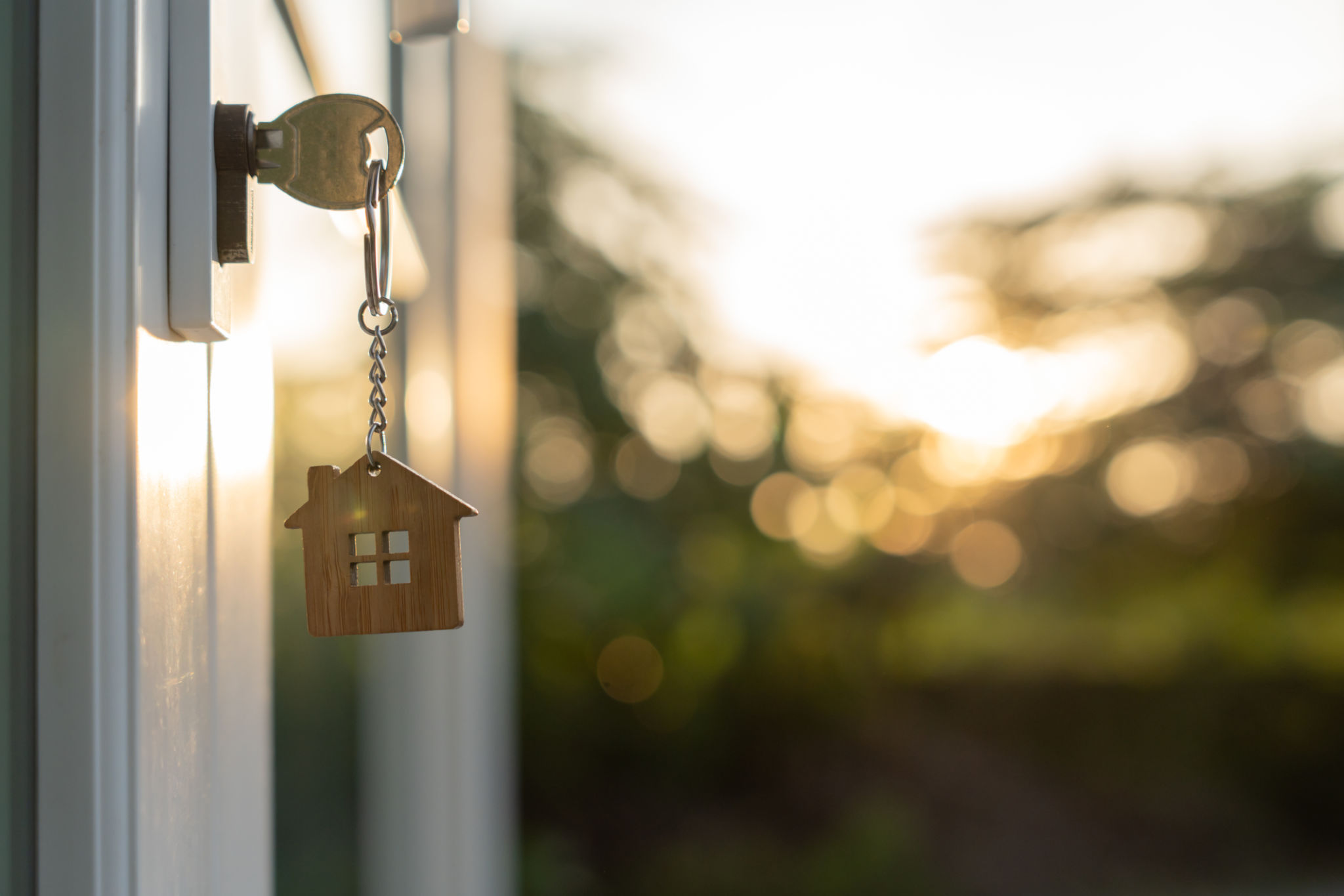 Landlord key for unlocking house is plugged into the door. Second hand house for rent and sale. keychain is blowing in the wind. mortgage for new home, buy, sell, renovate, investment, owner, estate Landlord key for unlocking house is plugged into the door. Second hand house for rent and sale. keychain is blowing in the wind. mortgage for new home, buy, sell, renovate, investment, owner, estate