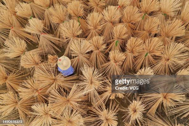 Aerial view of a worker drying bamboo sticks at a bamboo products manufacturing factory on May 16, 2023 in Taihe County, Ji an City, Jiangxi Province...
