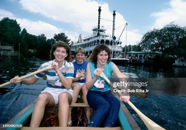Australia Olympic Team members Mariana Maffa , Julie Nykiel and Donna Quinn enjoy a canoe paddle during Teams visit to Disneyland, July 23, 1984 in...
