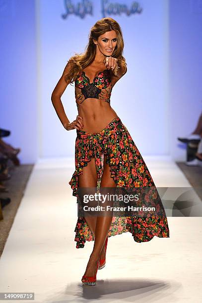 Model walks the runway during the Luli Fama "La Dolce Vita Miami" Collection presented during Mercedes-Benz Fashion Week Swim 2013 at The Raleigh on...