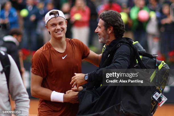 Holger Rune of Denmark celebrates with Patrick Mouratoglou after his victory against Novak Djokovic of Serbia in their Men's Singles quarter-final...