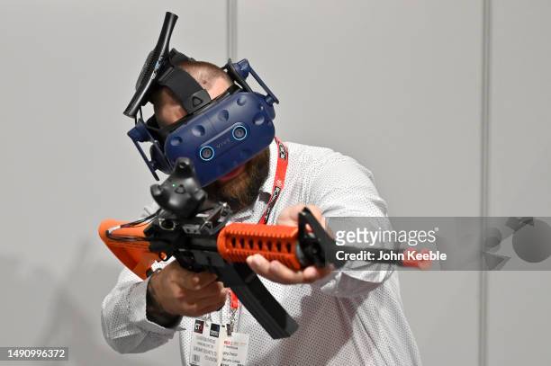 Visitor tries out the Street Smart VR semi automatic gun, weapons training platform with Vive 3D 360 degree virtual reality headset during the...