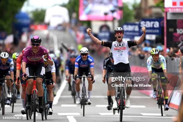 General view of Pascal Ackermann of Germany and UAE Team Emirates celebrates at finish line as stage winner ahead of Jonathan Milan of Italy and Team...