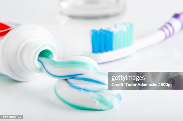 toothbrush,tube of toothpaste and a glass in the background,romania - 歯みがき粉 ストックフォトと画像