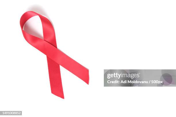 red ribbon on white background is symbol of disease aids and drug abuse,romania - aids awareness ribbon stock pictures, royalty-free photos & images