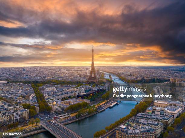 aerial view of paris with eiffel tower during sunrise - paris aerial stock pictures, royalty-free photos & images