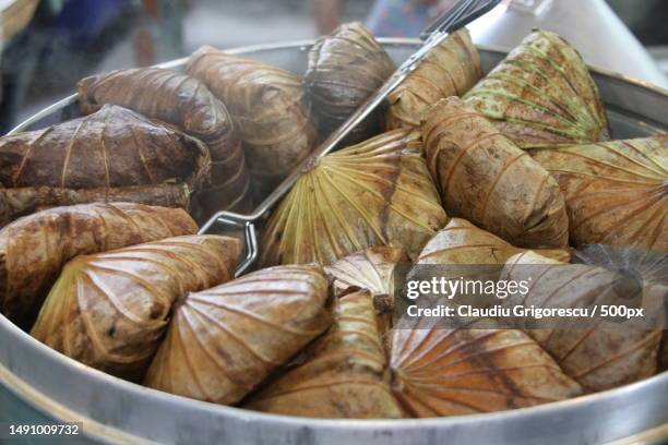 the rice wrapped in lotus leaf are steaming,romania - dining presentation food imagens e fotografias de stock