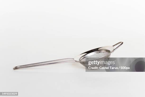 close-up of spoon over white background,romania - colander imagens e fotografias de stock