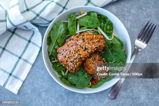 teriyaki fish with spinach in a bowl,romania - teriyaki stock pictures, royalty-free photos & images