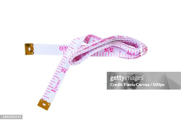 close-up of tape measure over white background,romania - meter unit of length ストックフォトと画像