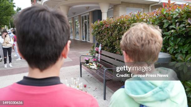 Two children look at the flowers and candles placed at the place where the macho murder took place in Orio, on 17 May, 2023 in Orio, Guipuzcoa,...