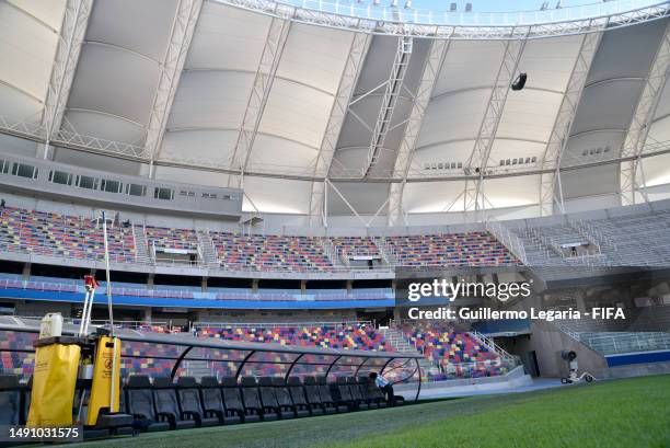 Woman cleans a bench inside Estadio Unico Madre de Ciudades Stadium on May 17, 2023 in Santiago del Estero, Argentina.