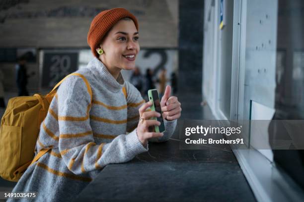 woman tourist enquiring for her train at help desk window at railway station - now showing stock pictures, royalty-free photos & images